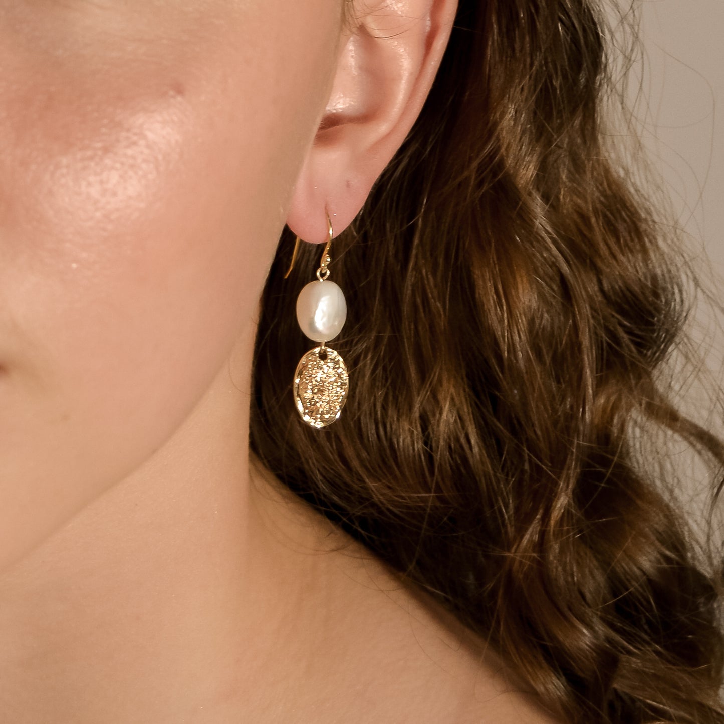model wearing Alexis wedding pearl, gold drop earrings, handmade