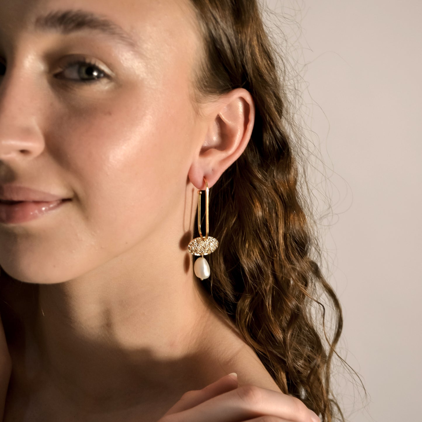 model wearing pearl, gold drop earings.  Handmade in store