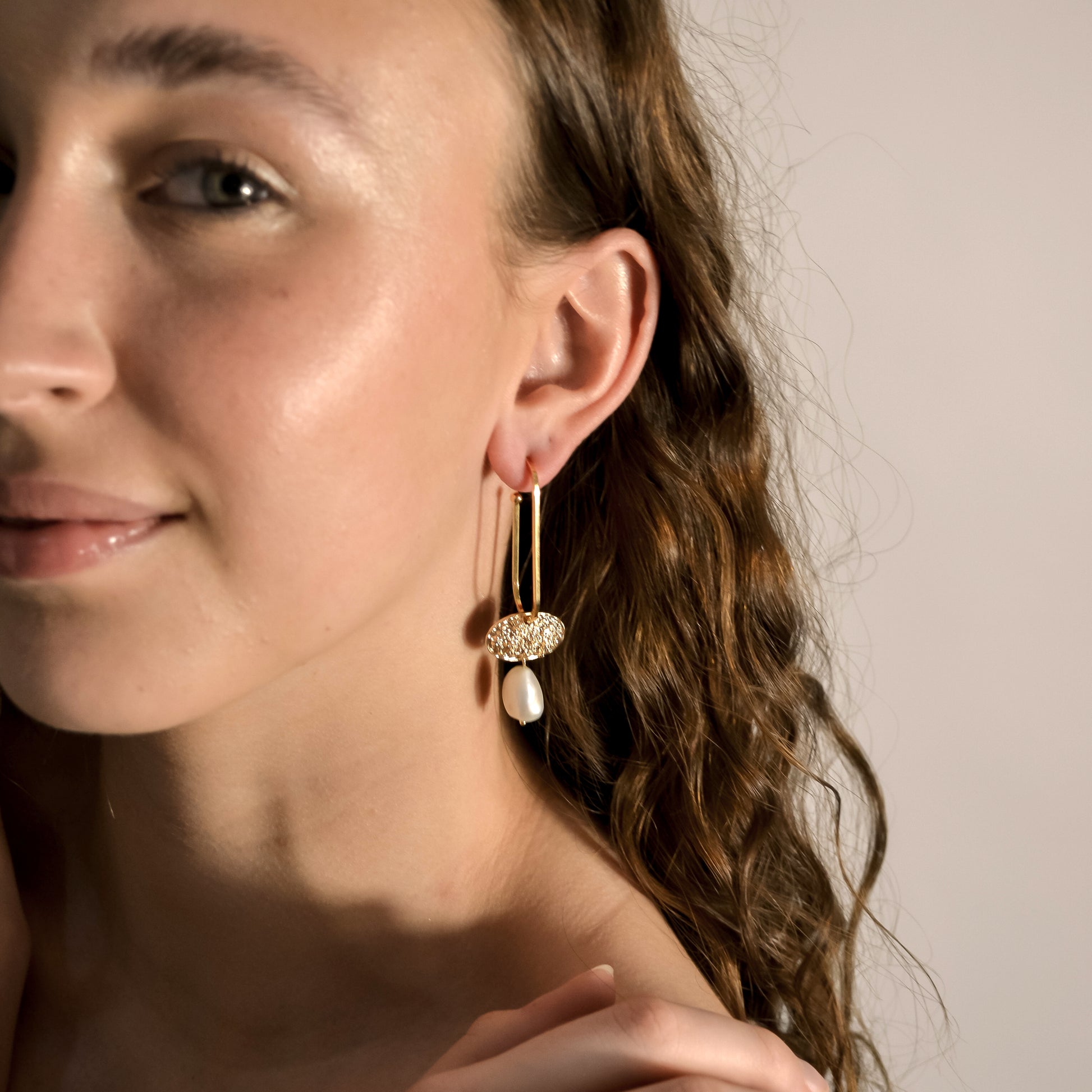 model wearing pearl, gold drop earings.  Handmade in store