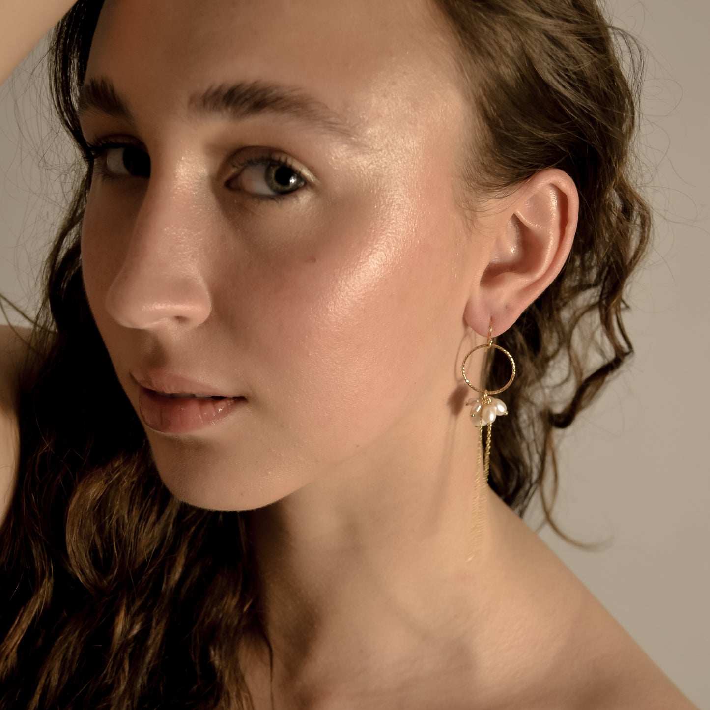 model wearing Arabella cluster wedding pearl drop earrings gold, hoop with chain