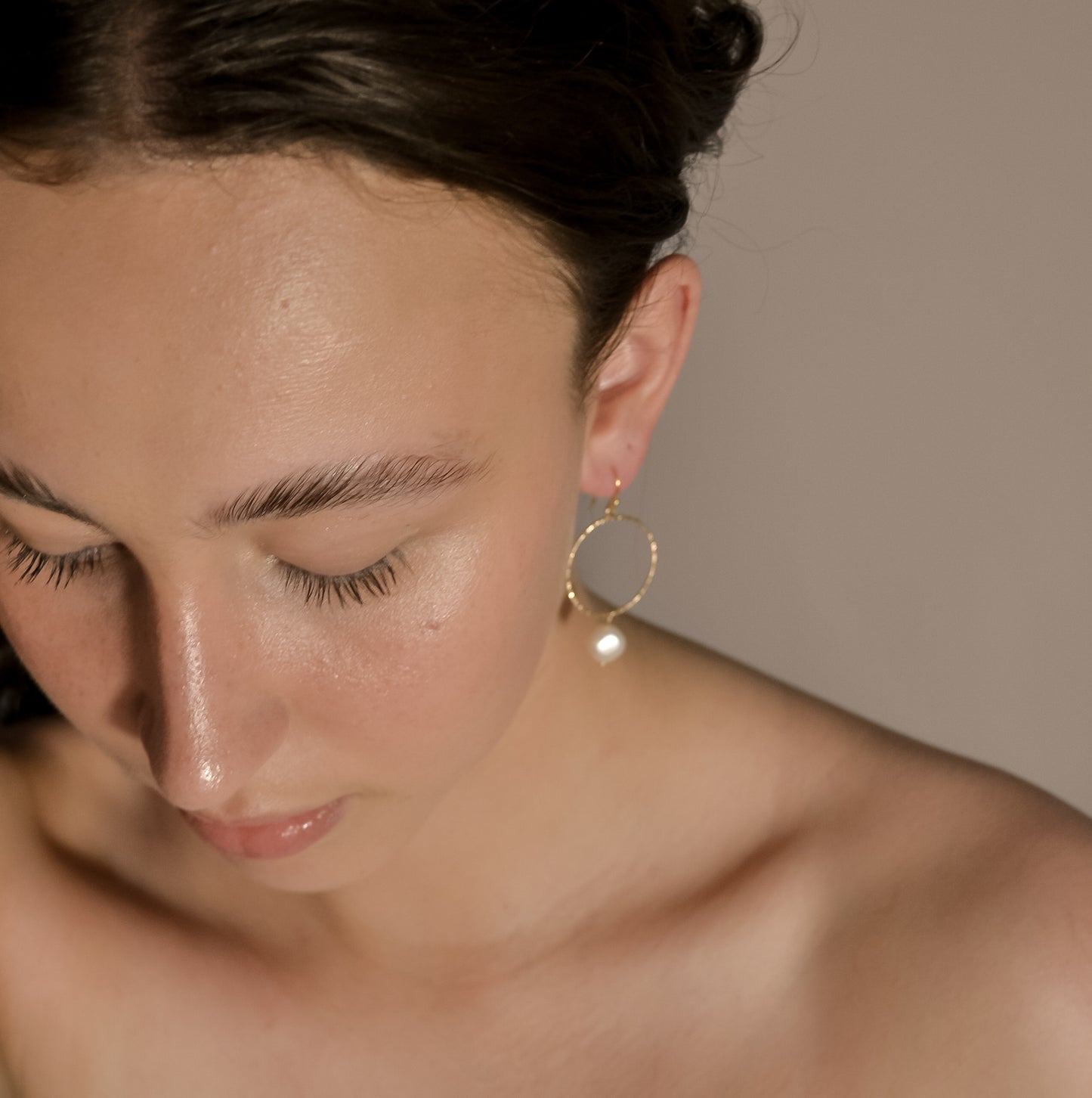 model wearing Avery range, gold stud with gold circle,  drop single pearl earrings
