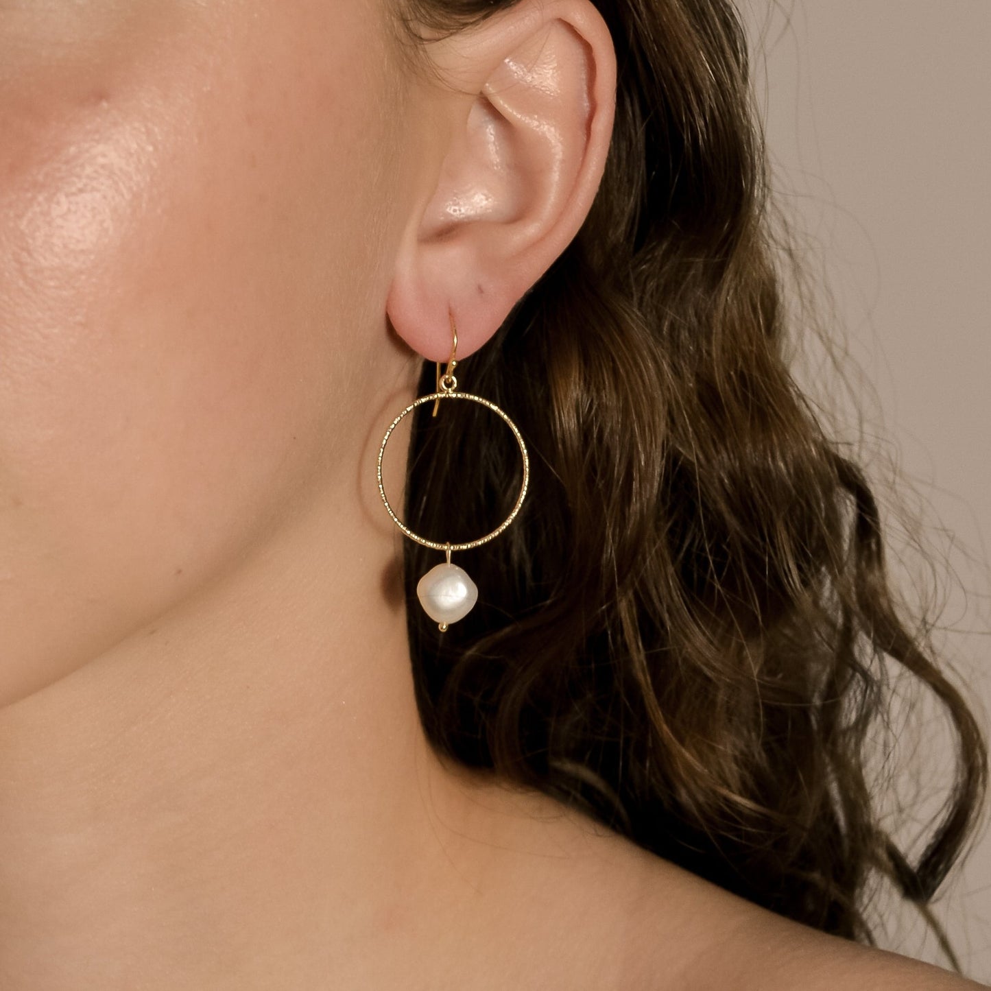 model wearing Avery range, gold stud with gold circle,  drop single pearl earrings