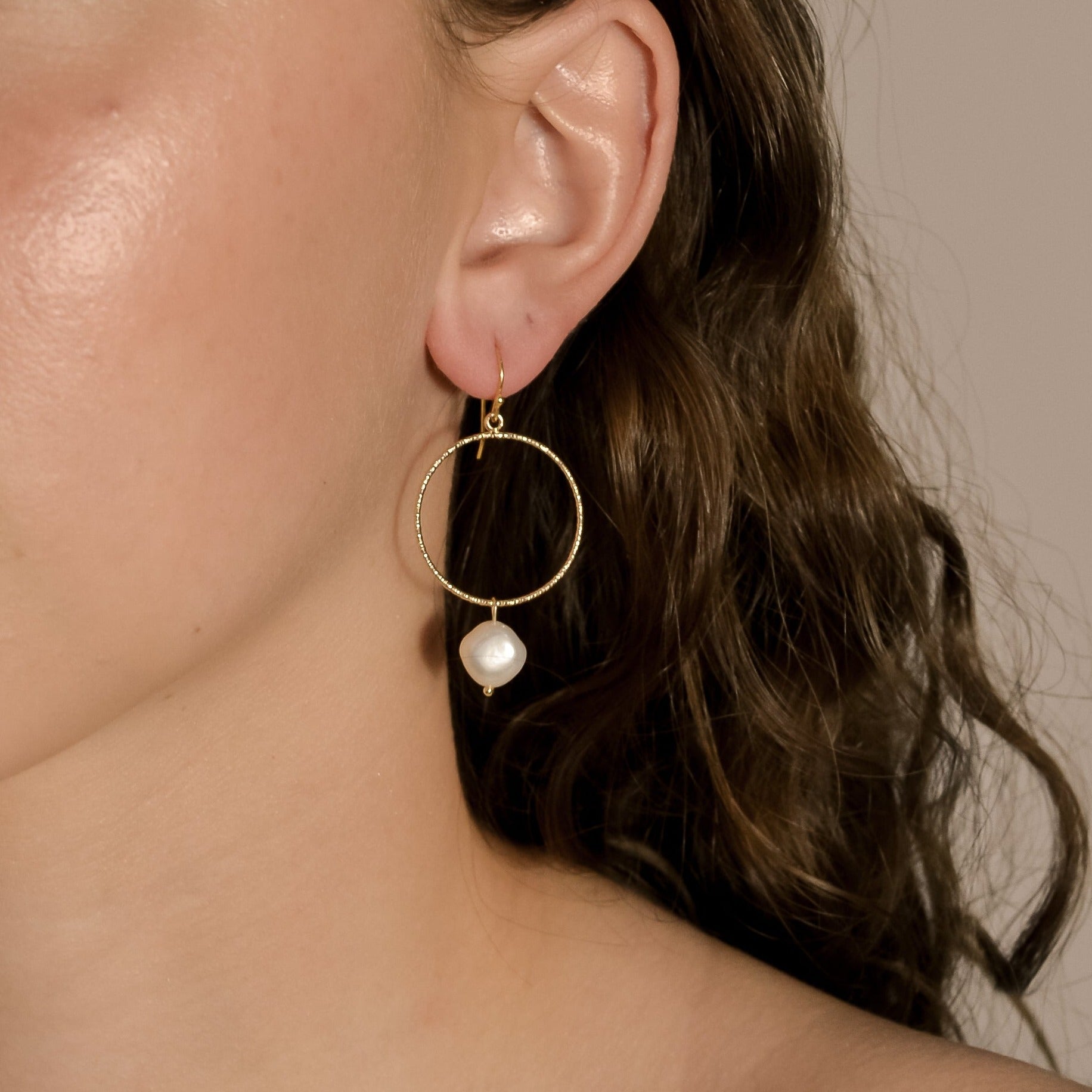 model wearing Avery range, gold stud with gold circle,  drop single pearl earrings