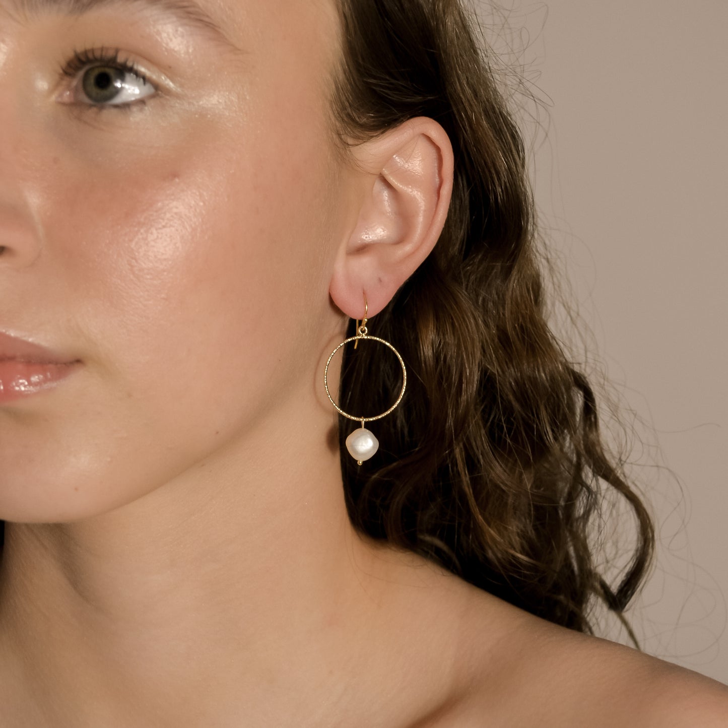 model wearing Avery range, gold stud with gold circle,  drop single pearl earrings