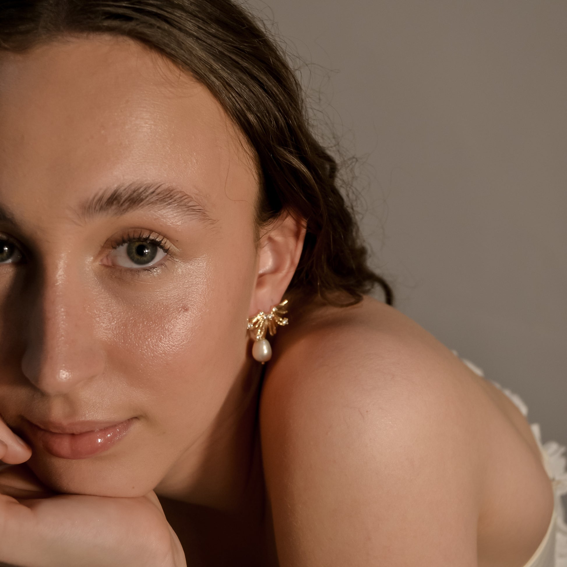 Model wearing Charlotte range, single pearl drop, gold, stud earrings