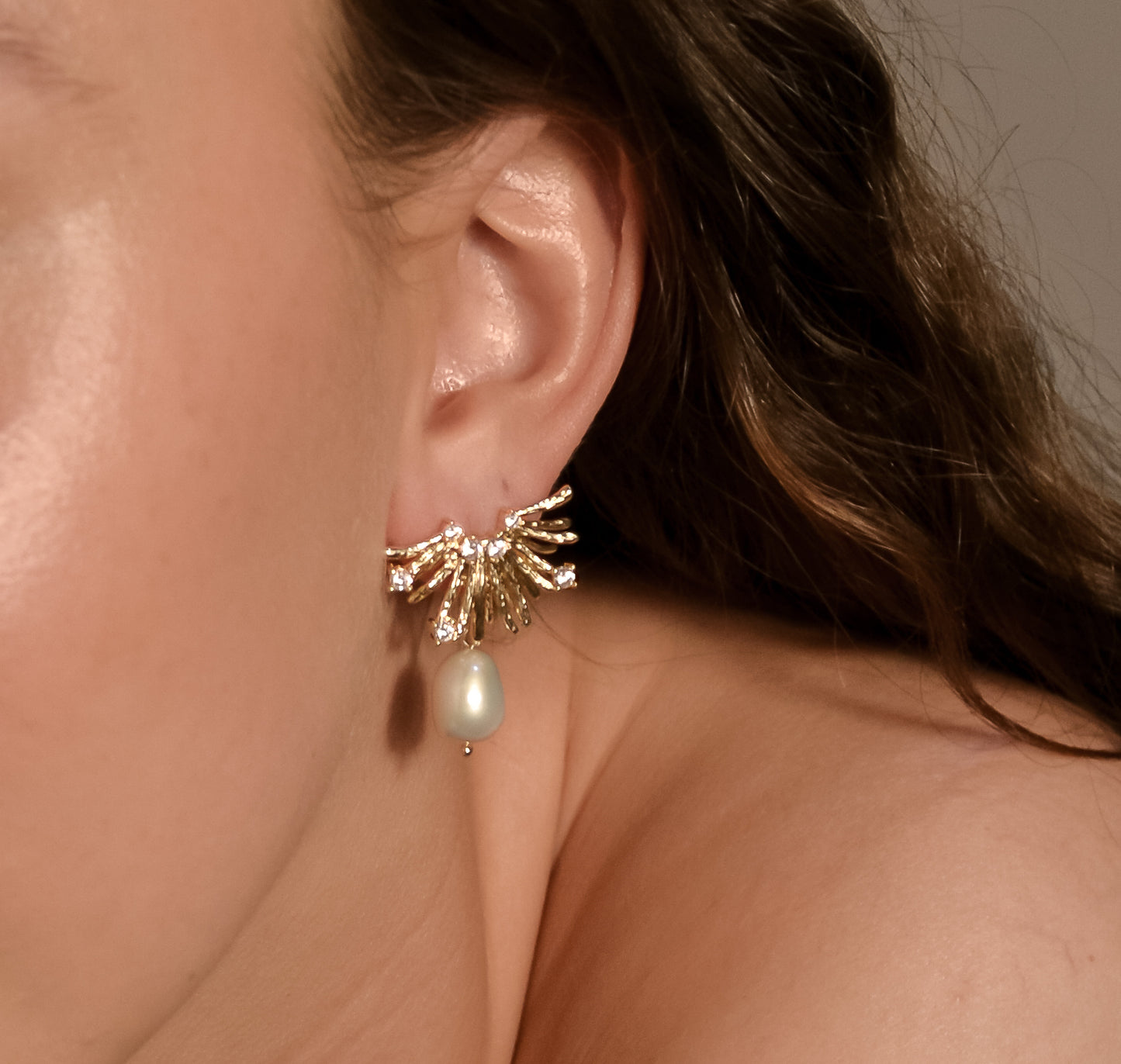 Model wearing Charlotte range, single pearl, gold, stud earrings