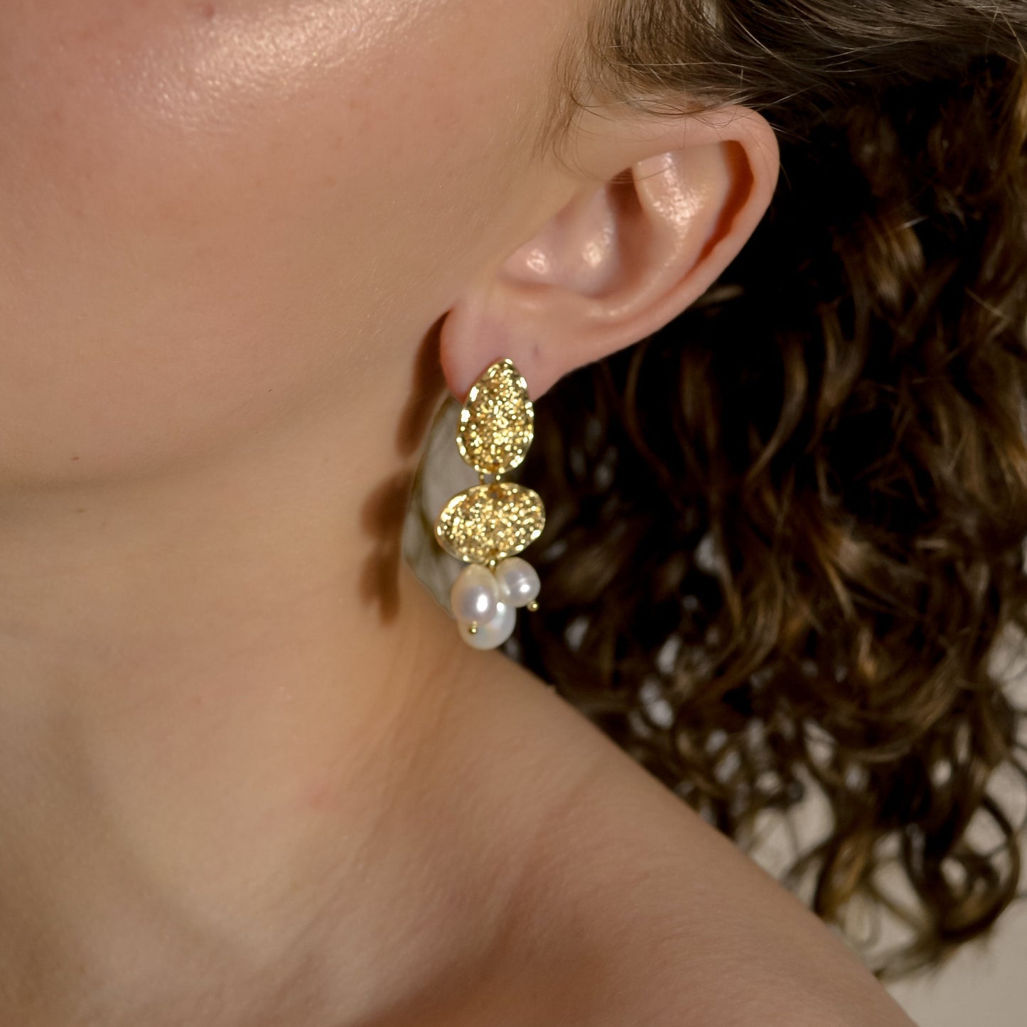 model wearing Clara range, gold bridal seed pearl modern drop earrings