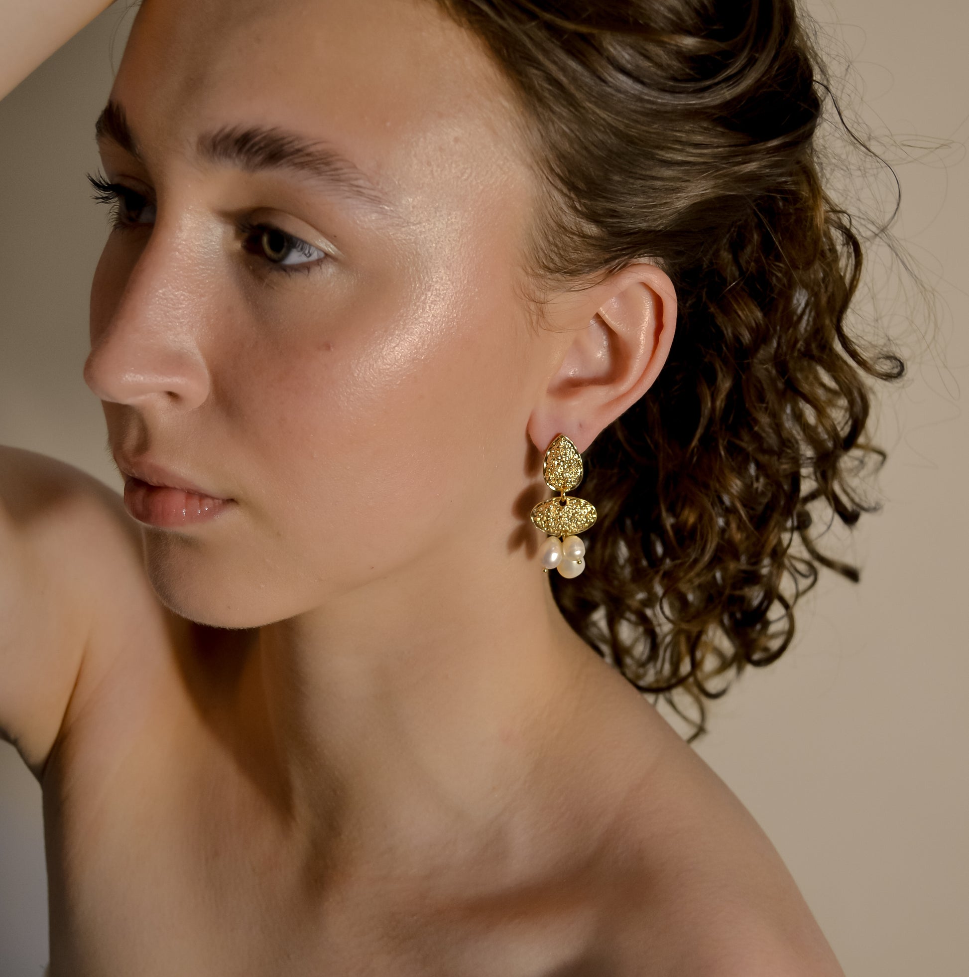 model wearing Clara collection, bridal seed pearl cluster with bold gold stud earrings