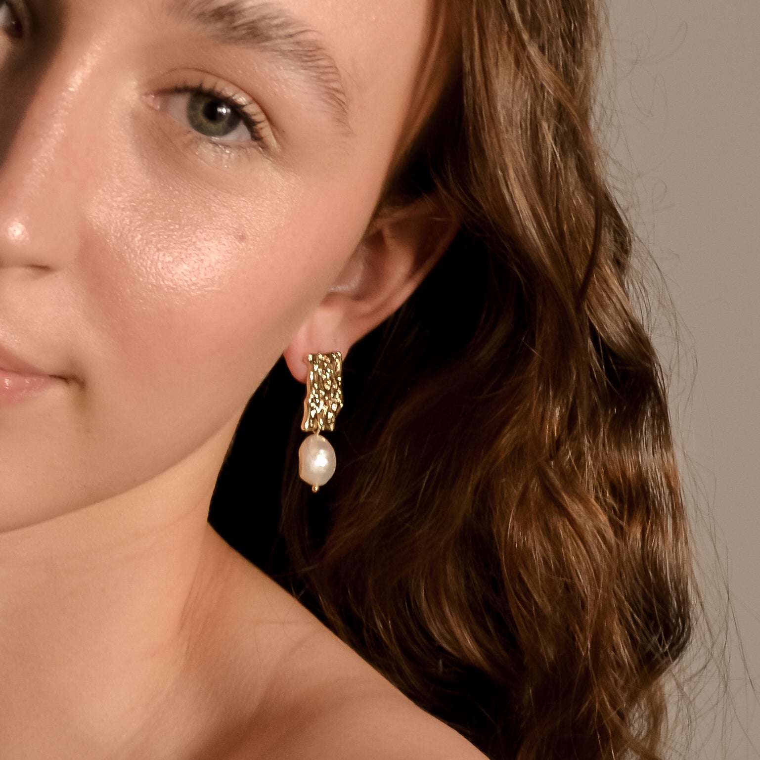 model wearing Genevieve collection, single large pearl, drop stud on gold pressed earring, unique stylish handmade s