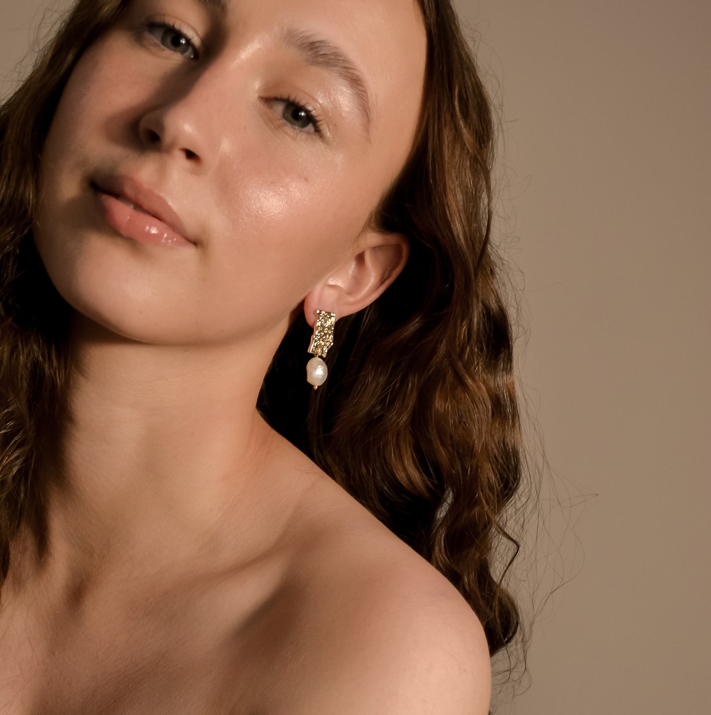 model wearing Genevieve collection, single large pearl, drop stud on gold pressed earring, unique stylish handmade s