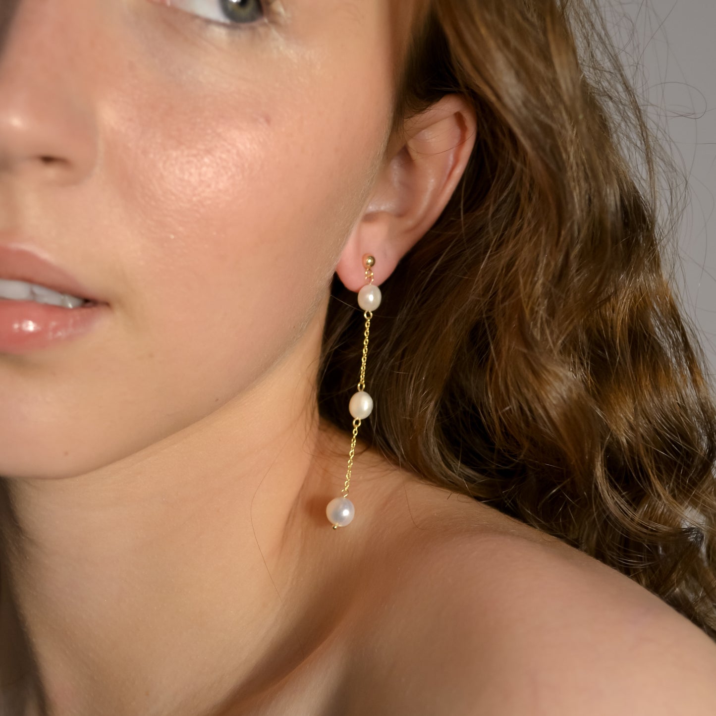 Model wearing Olivia collection, gold chain long drop, balls stud, 3 pearls, handmade earrings