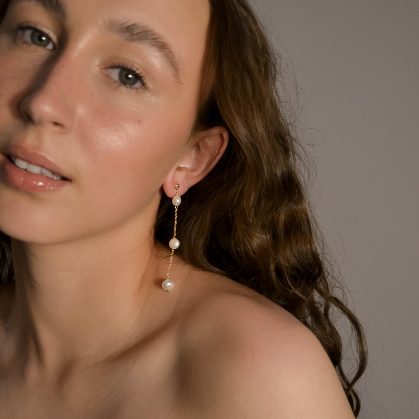 Model wearing Olivia collection, gold chain long drop, 3 pearls, handmade earrings