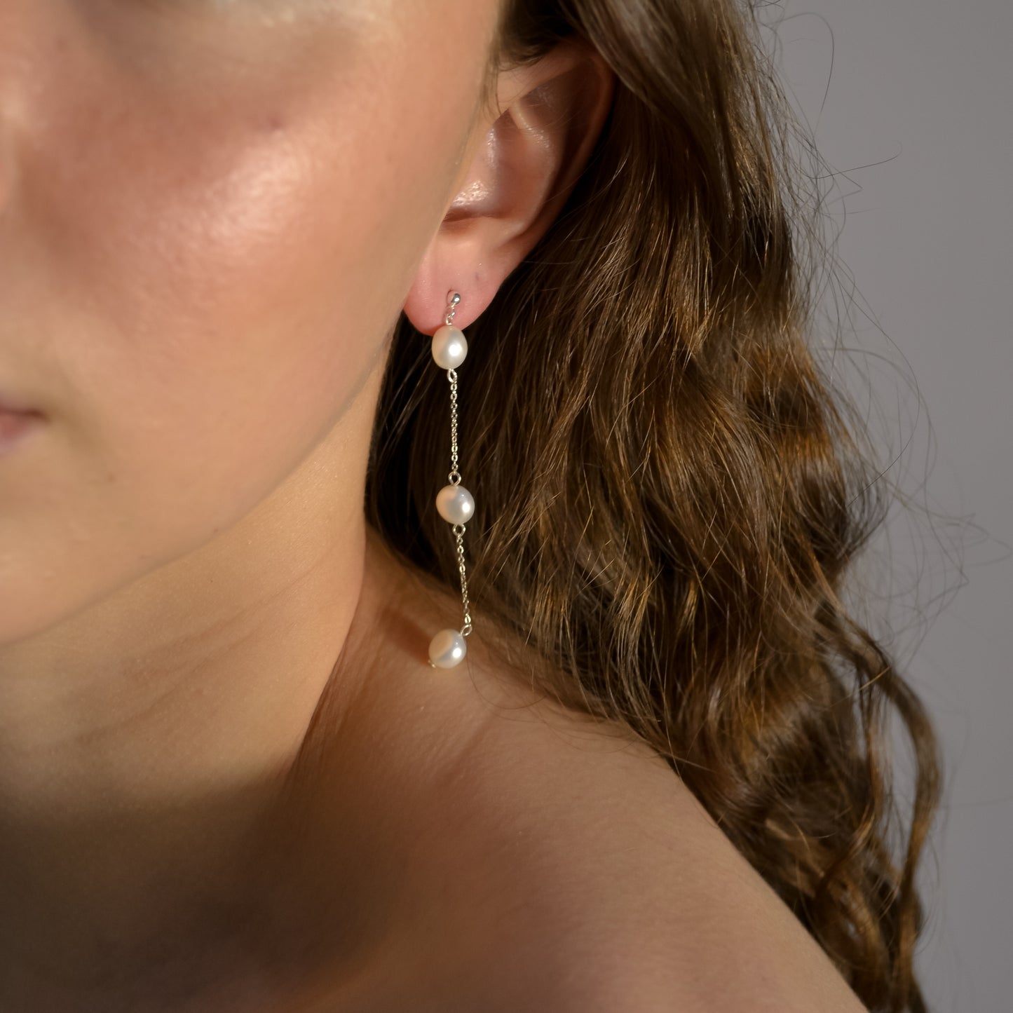 Model wearing Olivia collection, gold chain long drop, 3 pearls,ball stud,  handmade earrings