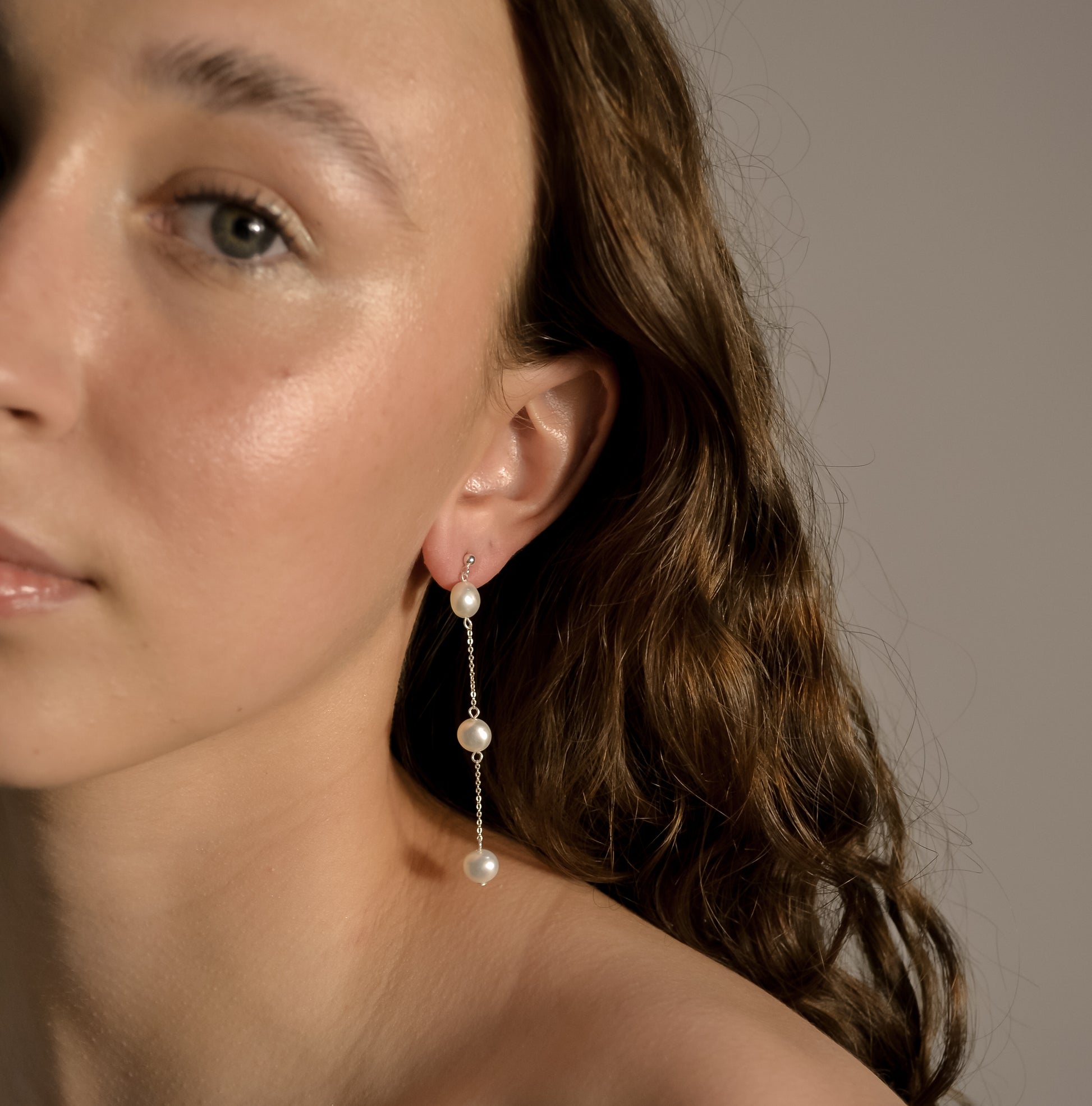 Model wearing Olivia collection, gold chain long drop, ball stud,  3 pearls, handmade earrings