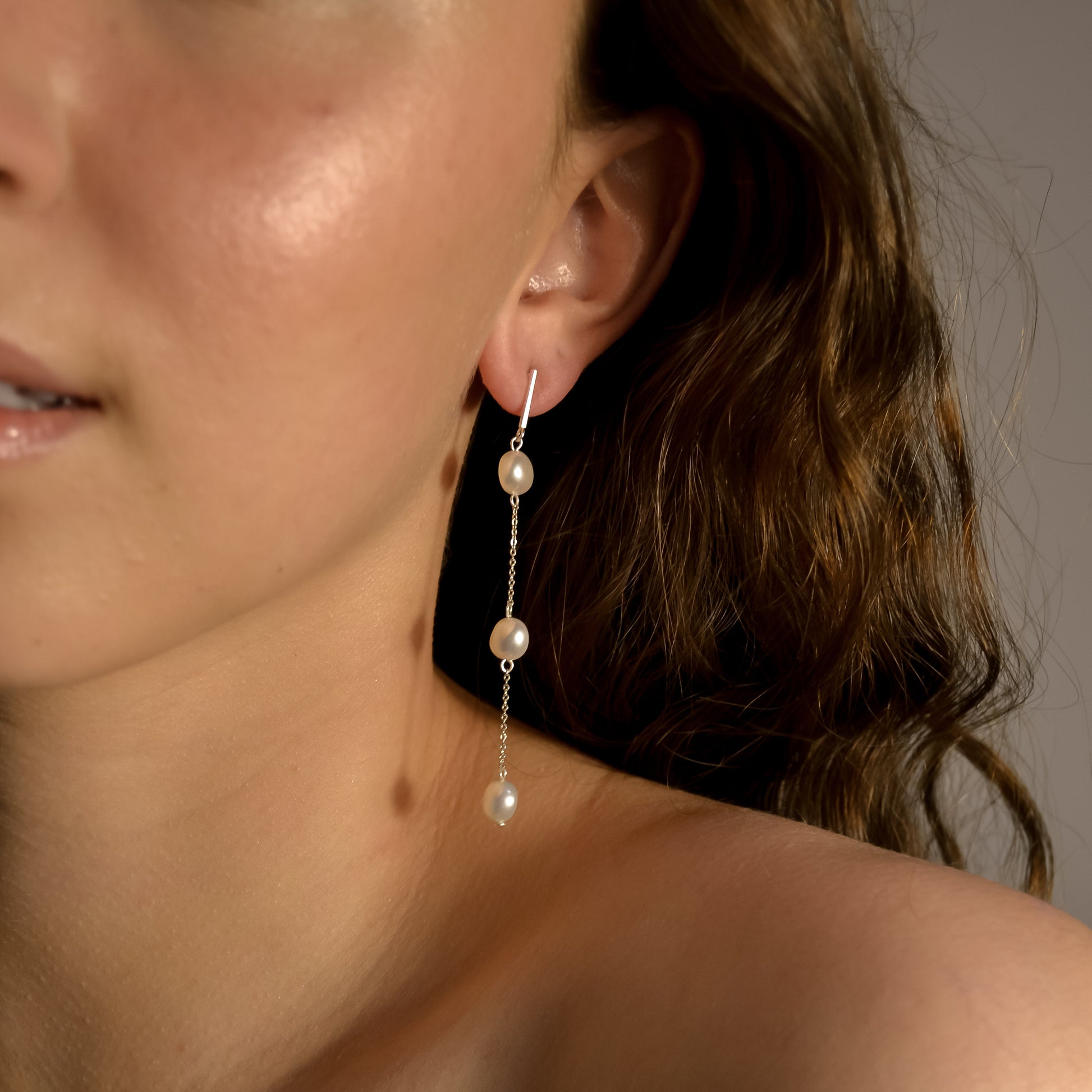 Model wearing Olivia collection, gold chain long drop, 3 pearls, handmade earrings