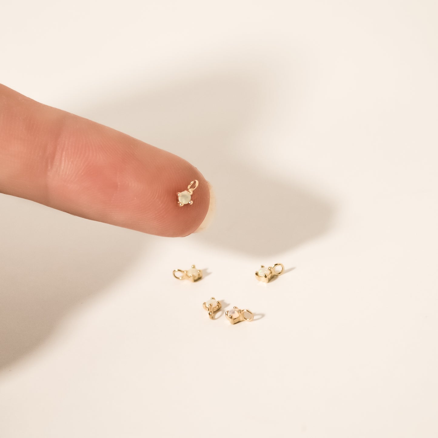 model holding opal charm tiny solid gold