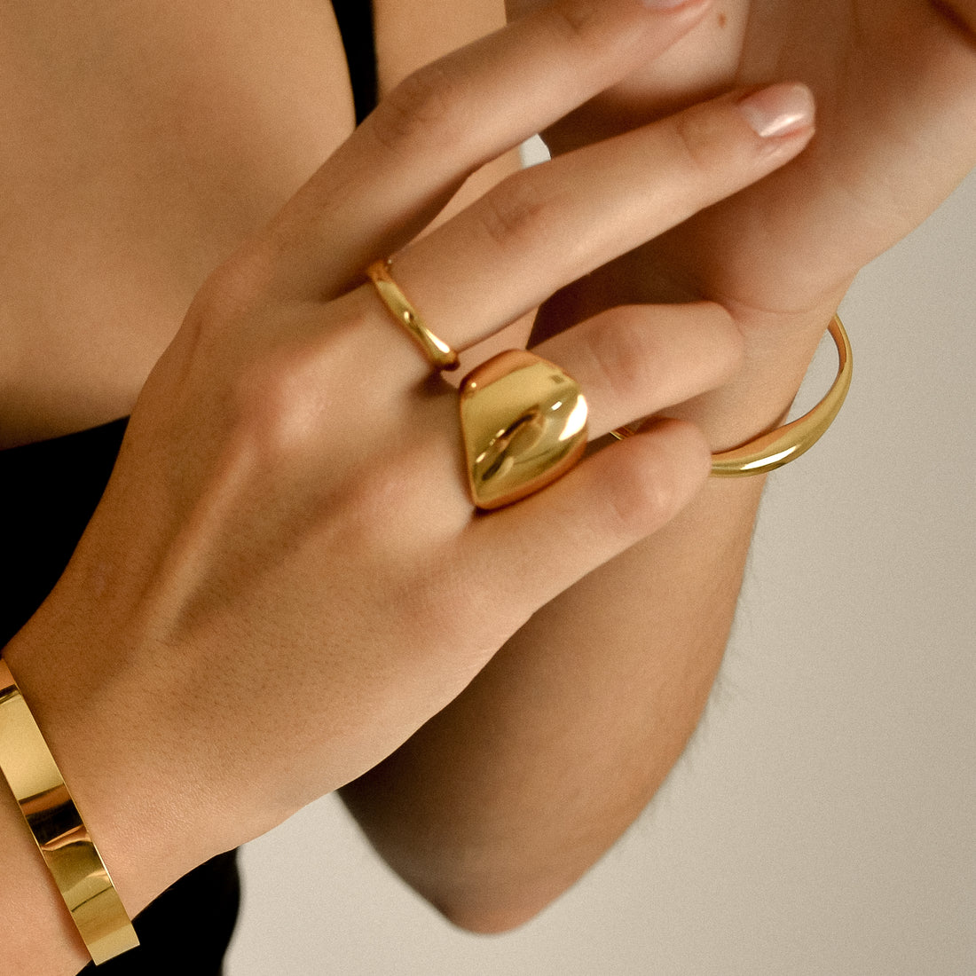 Rebellious Grace showcasing their new jewellery featuring chunky gold stacking rings of model
