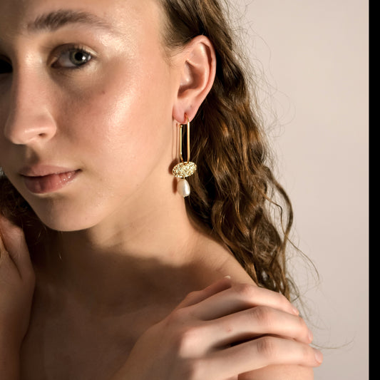 Anaise earrings on model, pearl, gold drop