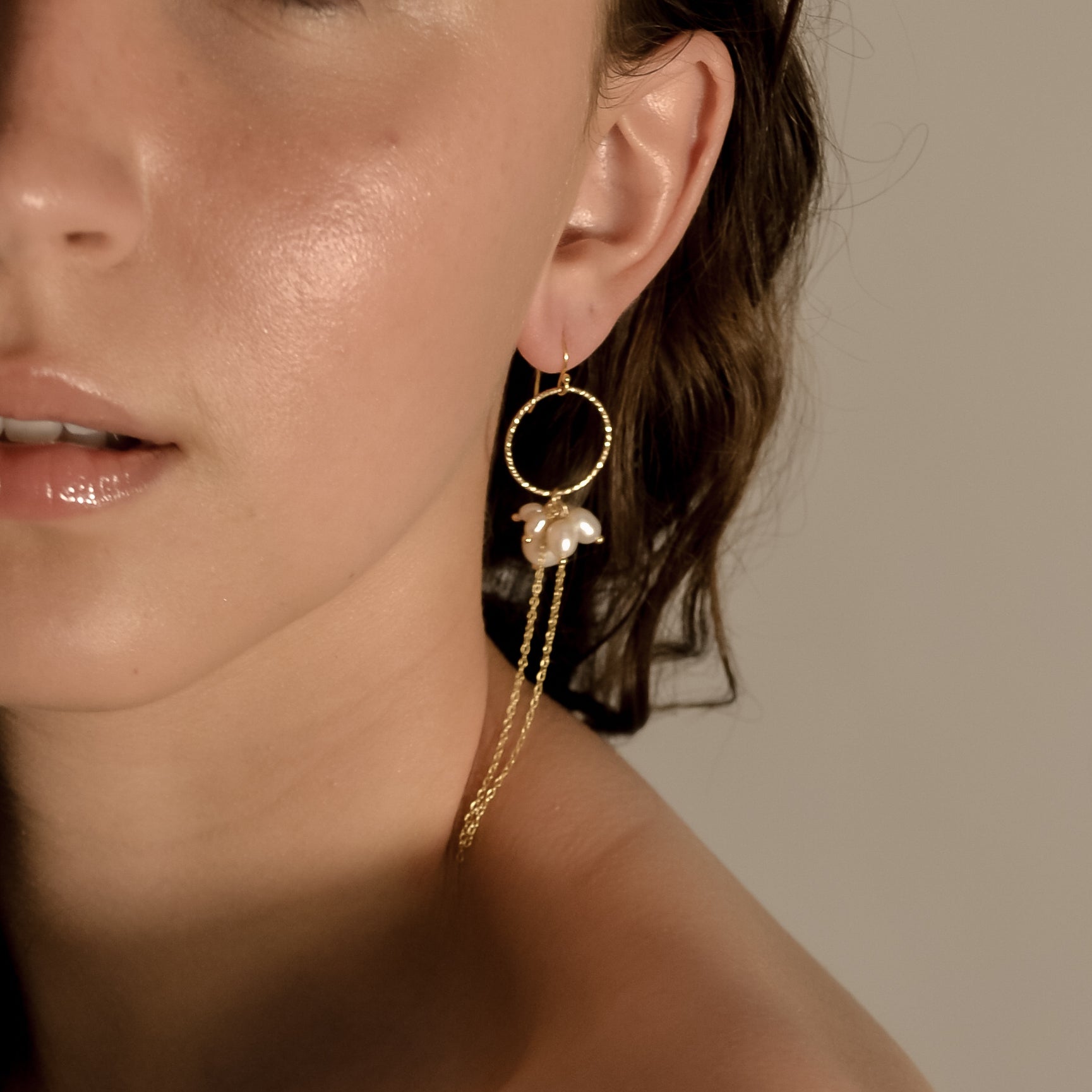 model wearing Arabella collection, pearl drop earring gold 