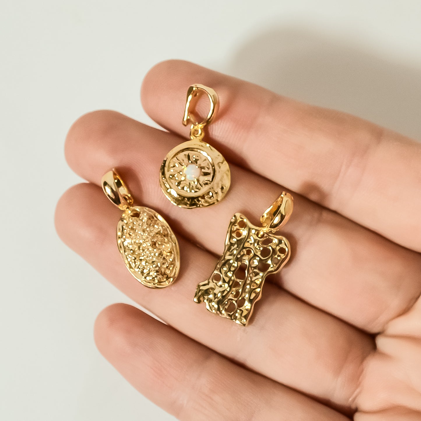 model holding gold charms, 