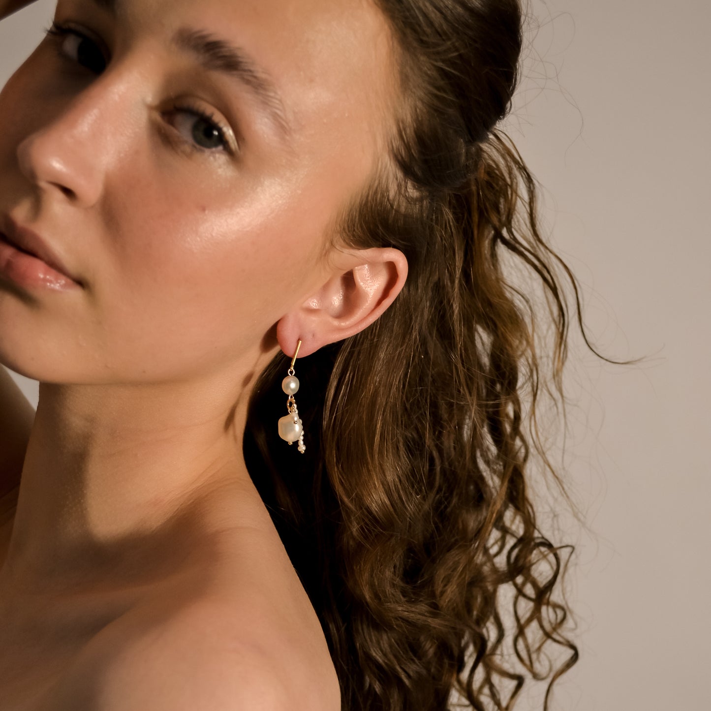 model wearing  Imogen double pearl drop chain gold earrings 