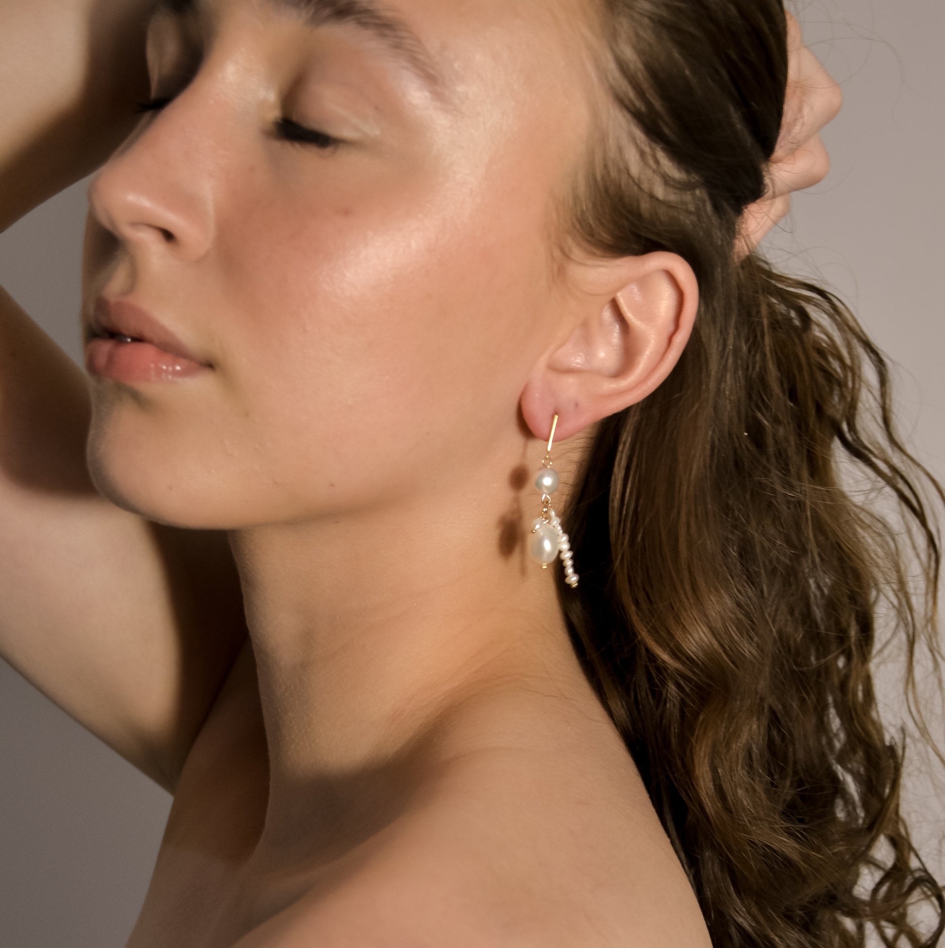 model wearing Imogen range, pearl double, chain drop gold earrings 