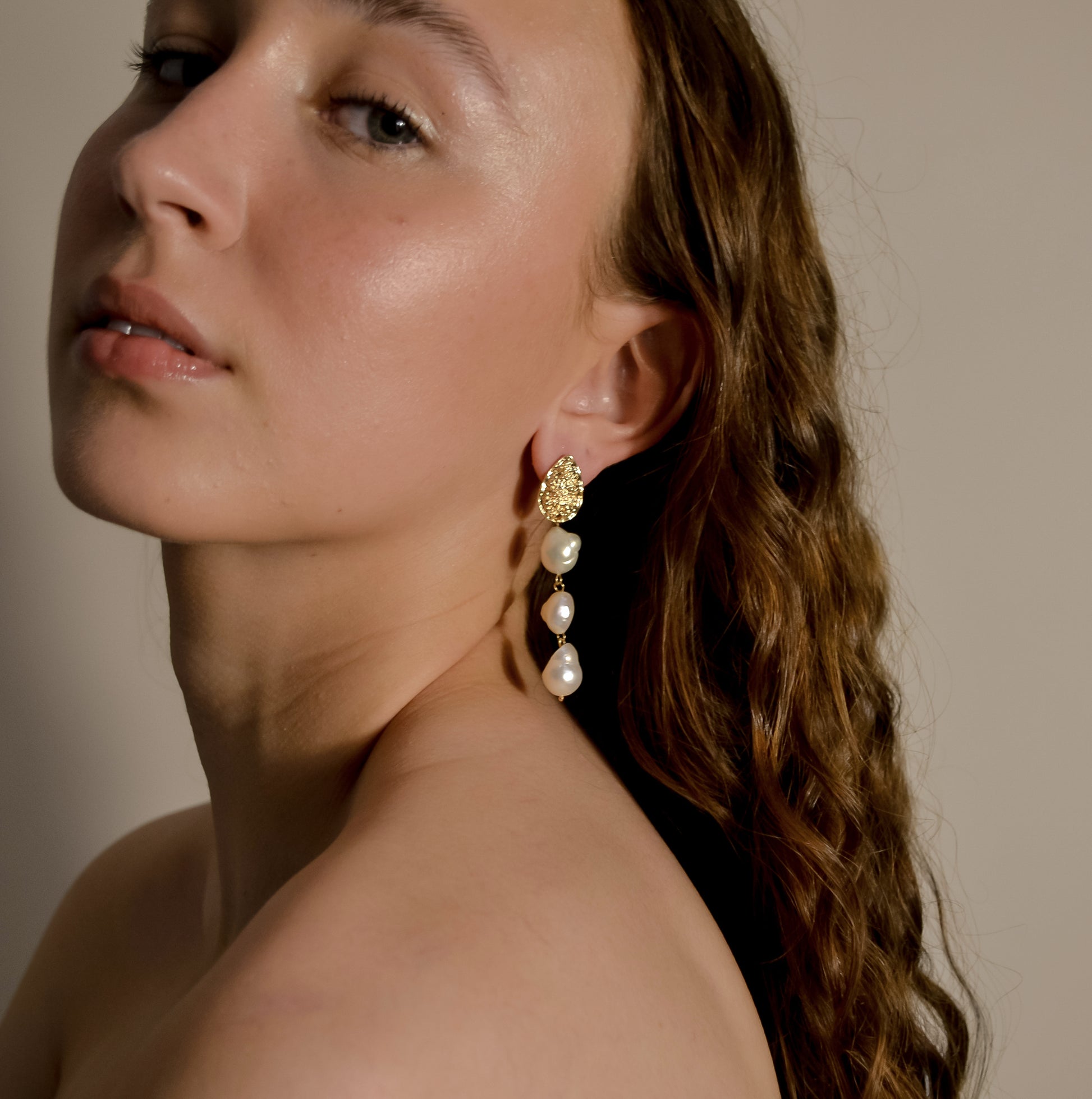 model wearing Josephine collection, bridal, 3 drop seed pearl large, gold pressed stud