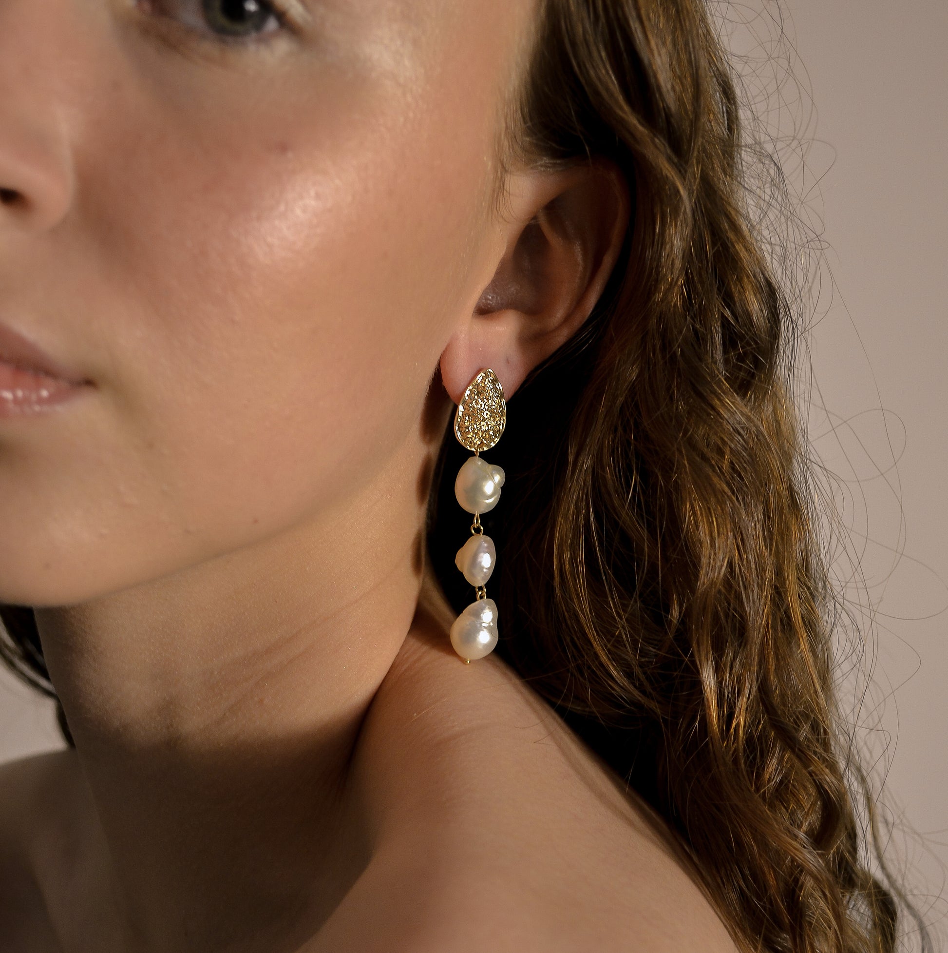 model wearing Josephine collection, bridal, 3 drop seed pearl large, gold pressed stud