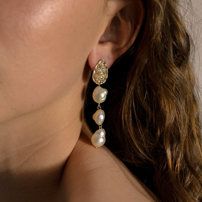 model wearing Josephine collection, bridal, 3 drop seed pearl large, gold pressed stud