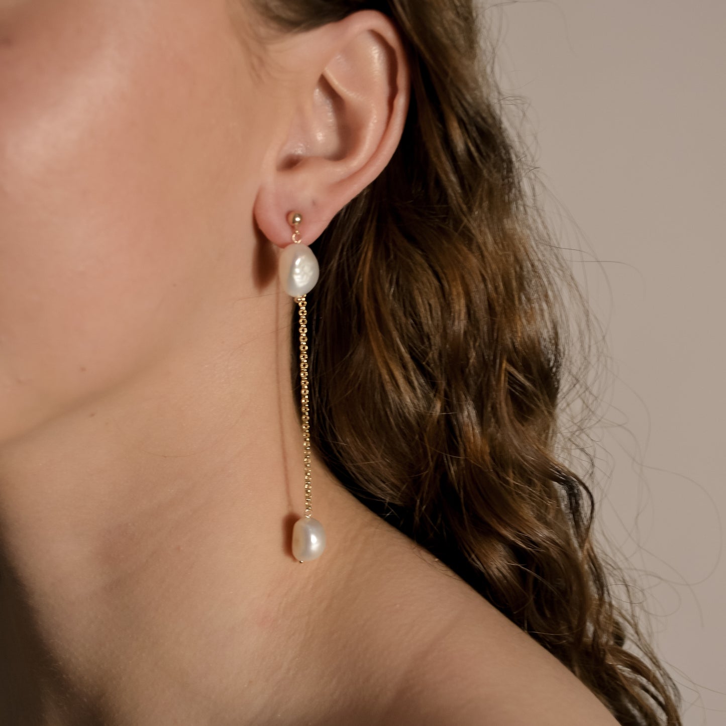 model wearing Lennon gold chain drop pearl earrings 