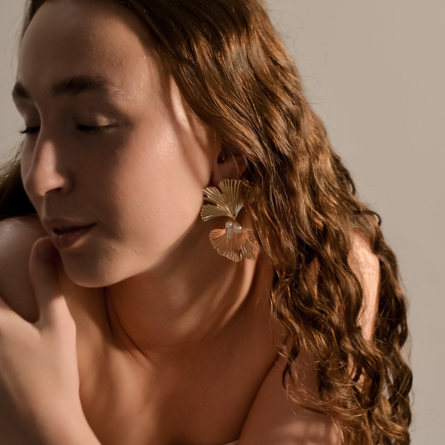 model wearing Melody collection, large gold fan with stud and 3 seed pearl cluster earrings 