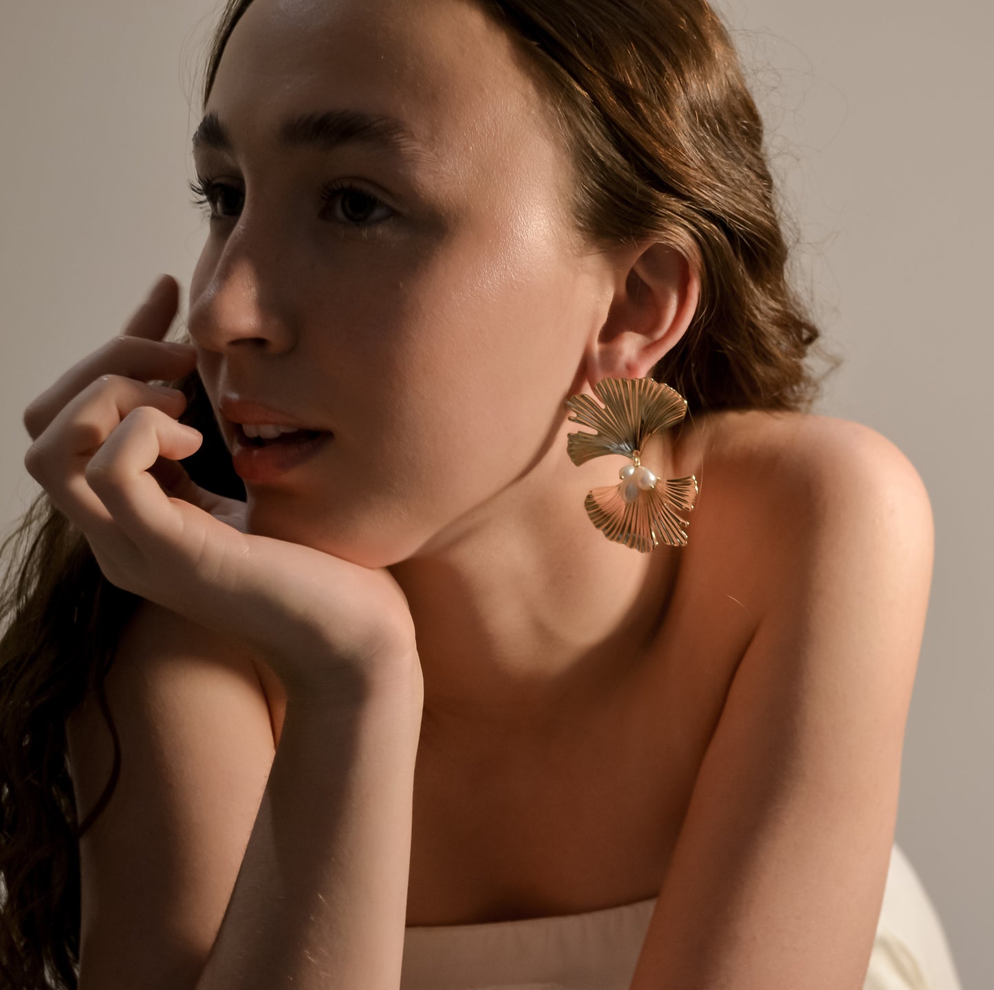model wearing Melody collection, large gold fan with stud and 3 seed pearl cluster earrings 