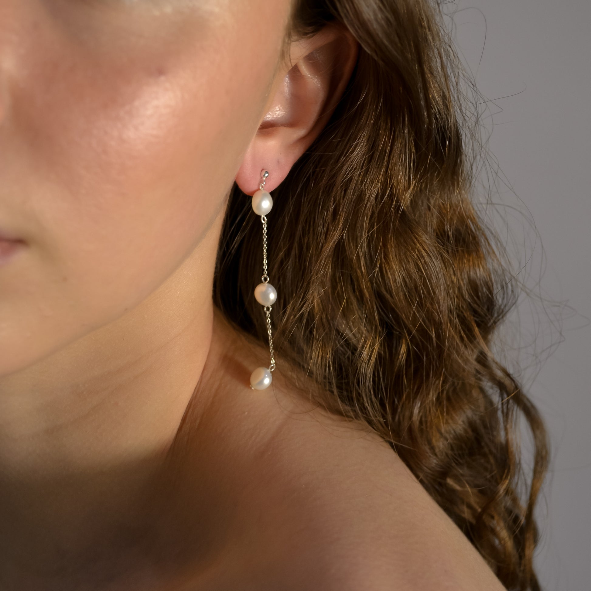 Model wearing Olivia collection, gold chain long drop, 3 pearls,ball stud,  handmade earrings 