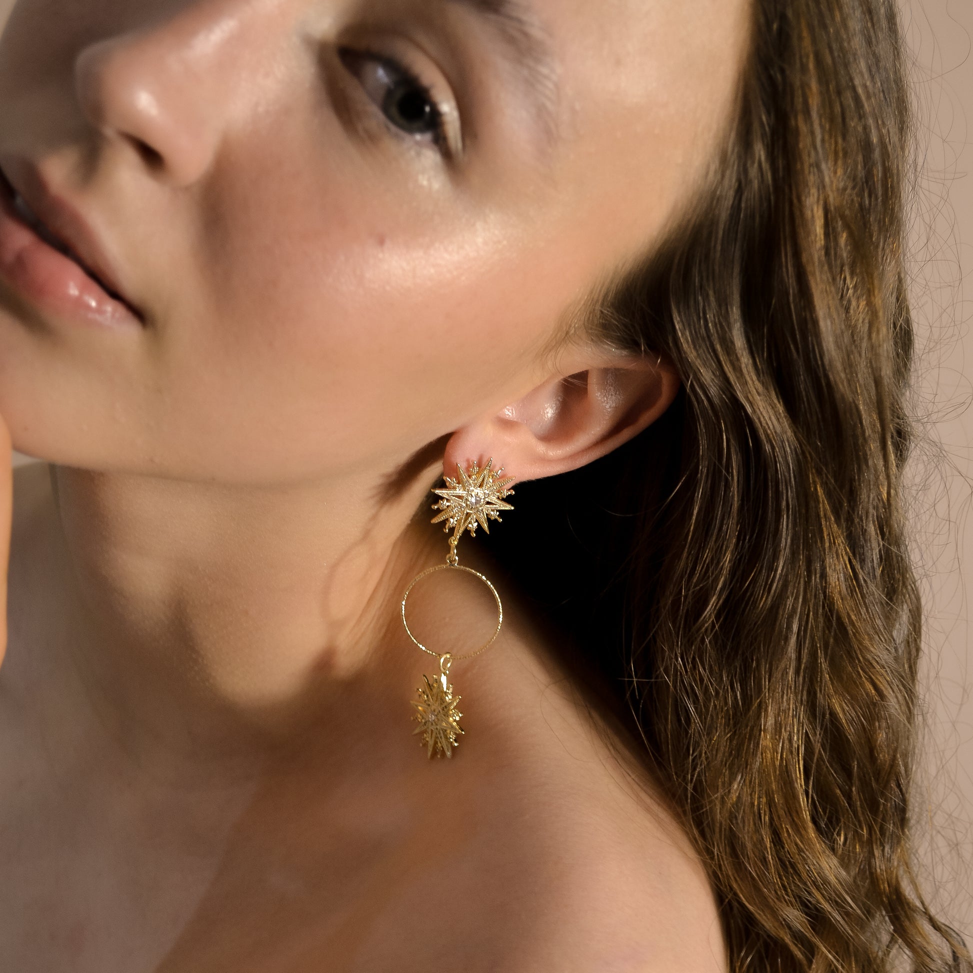 Model wearing Valentina range, unique gold earrings, gold star with circle, handmade designer