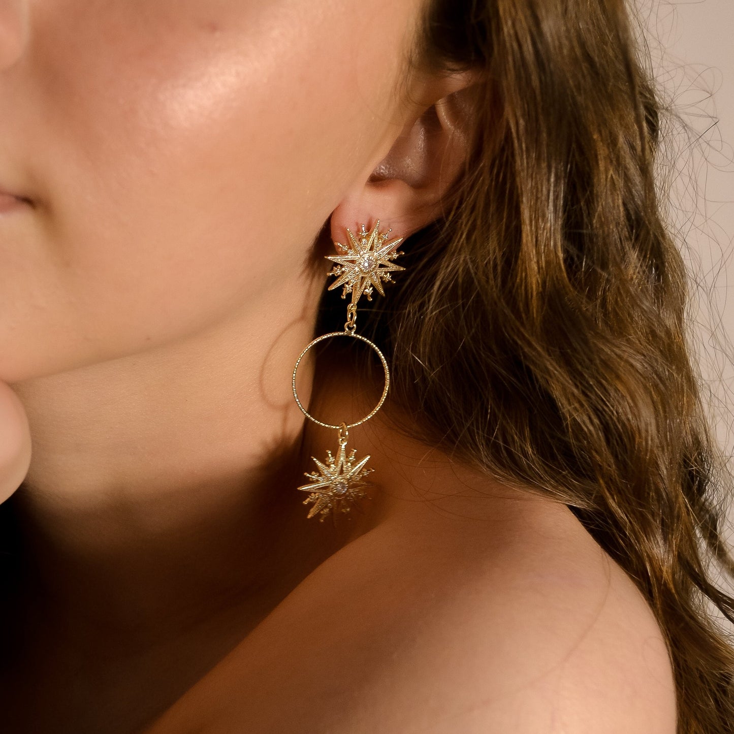 Model wearing Valentina range, unique gold earrings, gold star with circle, handmade designer 